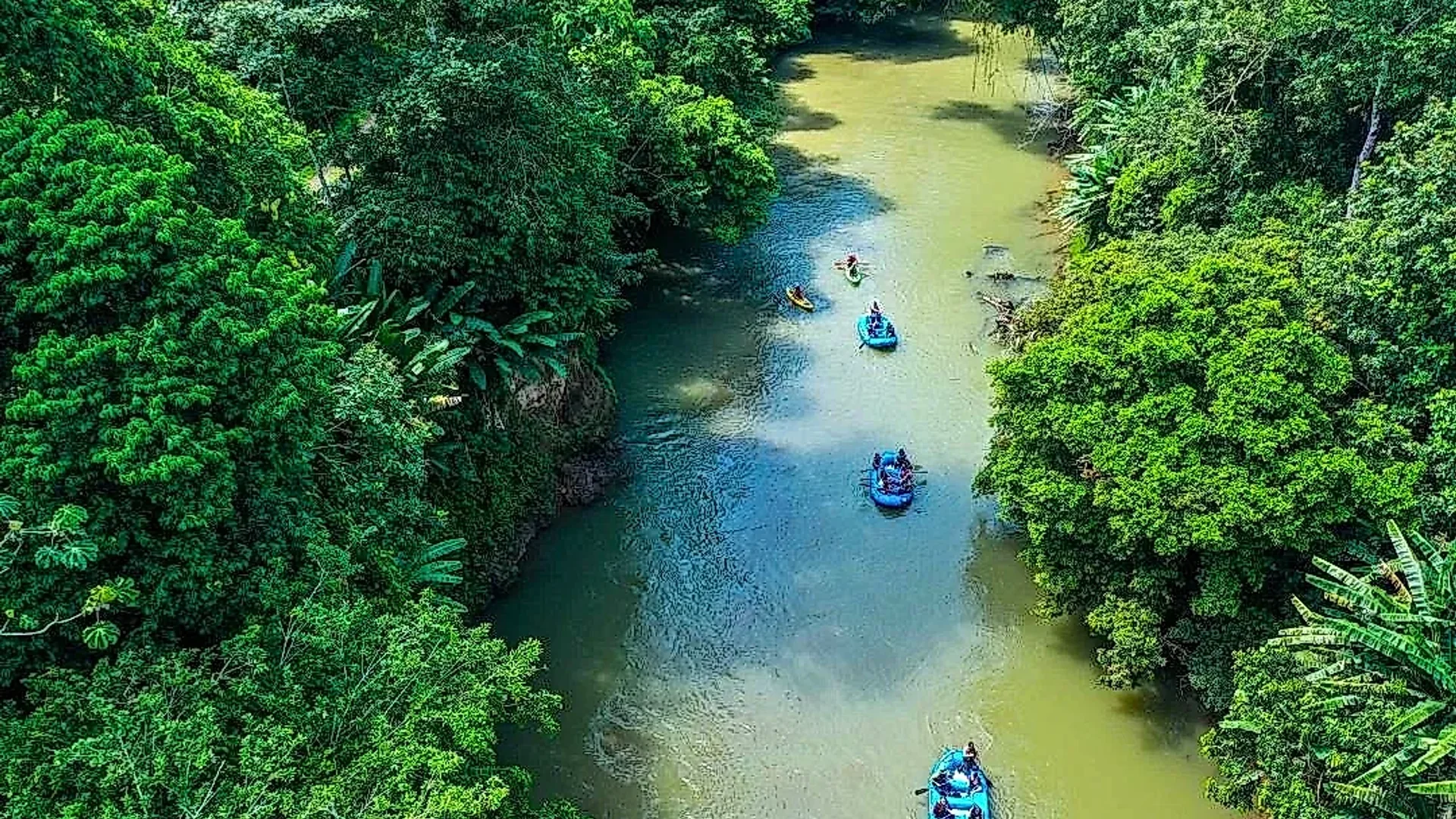 Raft peacefully traveling down the Peñas Blancas River during the Safari Float in La Fortuna.